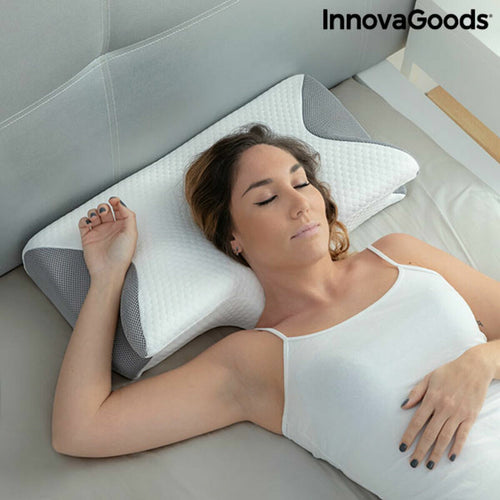 Woman sleeping on a white and grey contoured fabric neck pillow by InnovaGoods.