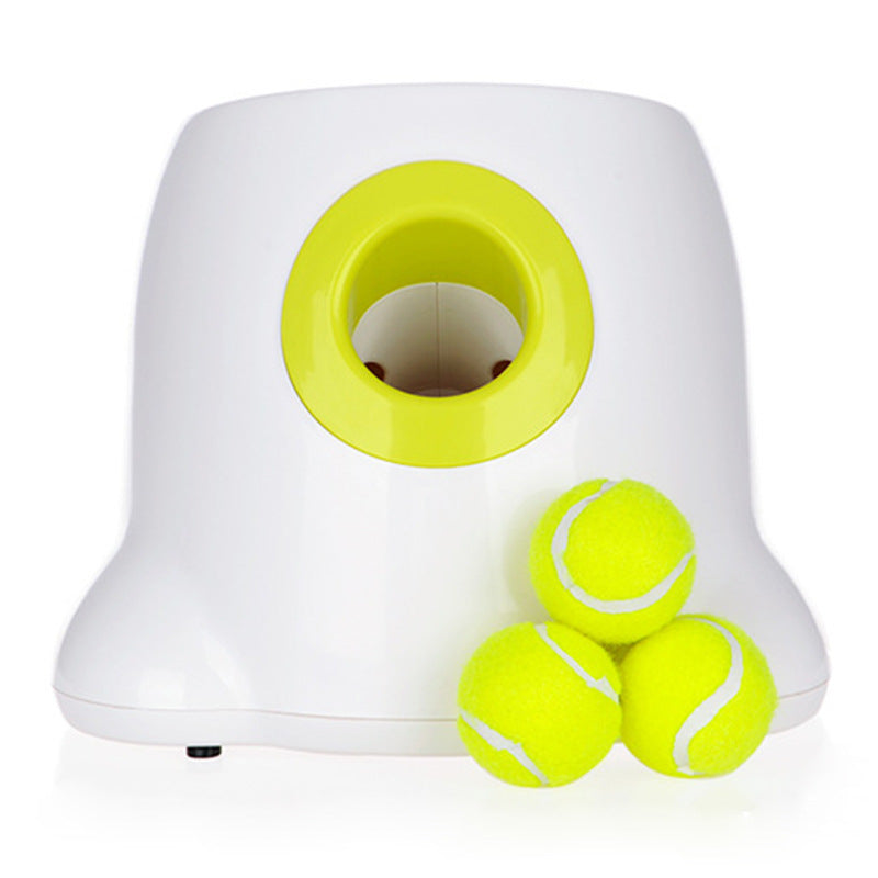 White plastic automatic ball launcher with a lime green opening and three yellow tennis balls.